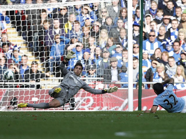 Wigan Athletic's goalkeeper Joel Robles saves a shot from Manchester City's Carlos Tevez during the FA Cup Final on May 11, 2013
