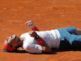 Rafael Nadal from Spain falls to the ground in celebration after winning the final of the Madrid Masters on May 12, 2013