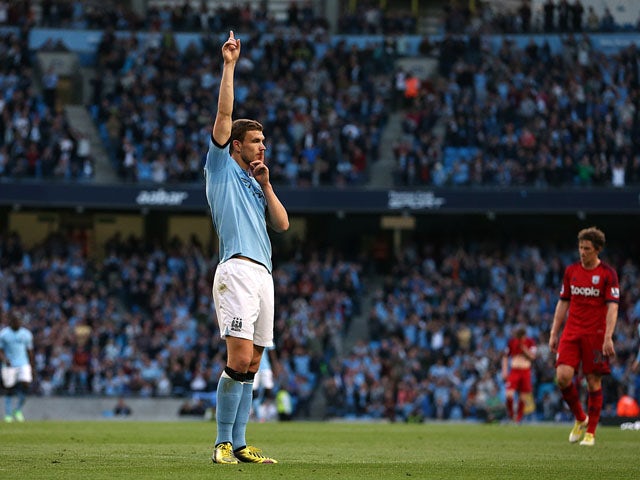 Manchester City's Edin Dzeko celebrates scoring against West Bromwich Albion on May 7, 2013