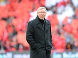 Manchester United manager Sir Alex Ferguson emerges from a guard of honour before his last home match in charge of the club on May 12, 2013