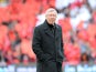 Manchester United manager Sir Alex Ferguson emerges from a guard of honour before his last home match in charge of the club on May 12, 2013
