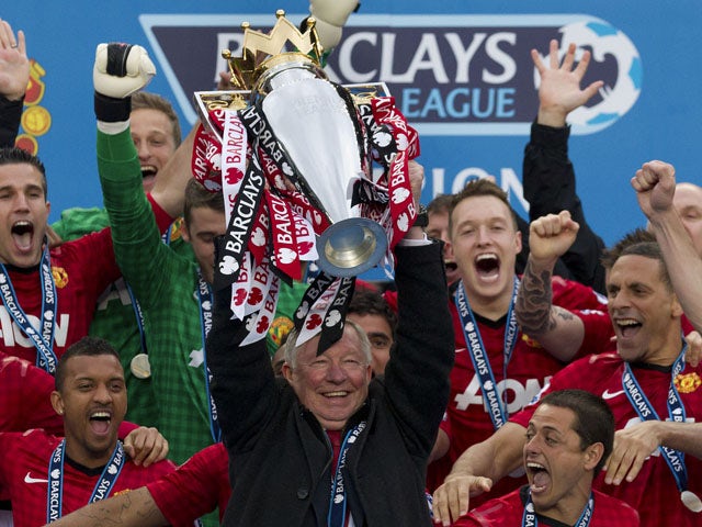 Manchester United manager Alex Ferguson lifts the Premier League trophy on May 12, 2013
