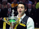 Ronnie O'Sullivan celebrates with the trophy after beating Barry Hawkins in the World Championship final on May 6, 2013