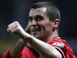 Roy Keane smiling after scoring a goal for Manchester United.