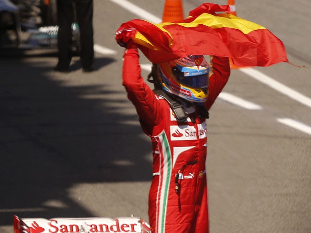 Ferrari driver Fernando Alonso of Spain celebrates his victory after wining the Formula One Spanish Grand Prix on May 12, 2013