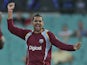 West Indies' Sunil Narine raises arms in jubilation after taking the wicket of Australia's Aaron Finch on February 8, 2013