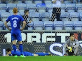 Wigan players look dejected following Swansea City's third goal on May 7, 2013