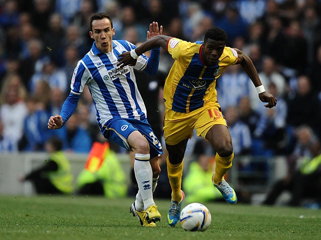 Brighton's David Lopez and Crystal Palace's Wilfried Zaha battle for the ball on May 13, 2013