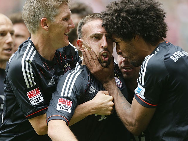 Bayern's Franck Ribery is mobbed by team mates after scoring his second goal against Borussia Monchengladbach on May 18, 2013