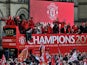 Manchester United players and staff celebrate on the bus during the winners parade on May 13, 2013