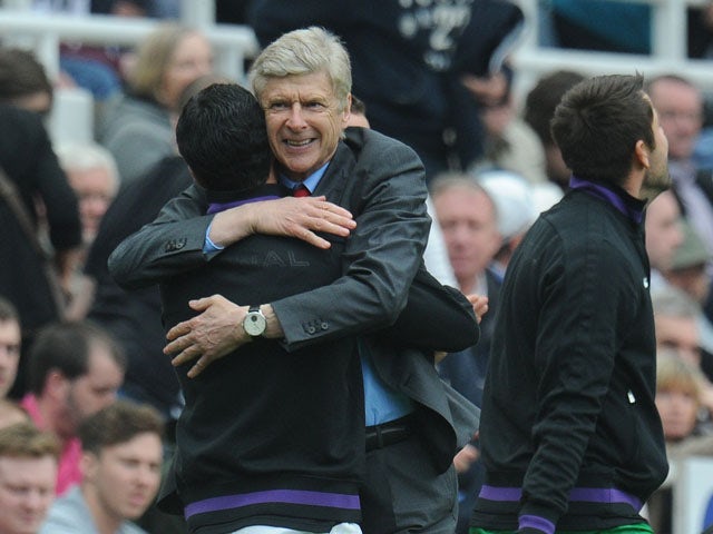 Arsenal manager Arsene Wenger celebrates after the final whistle in the Premier League match against Newcastle on May 19, 2013