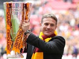 Bradford boss Phil Parkinson celebrates with the trophy after his team beat Northampton in the League Two play off final on May 18, 2013