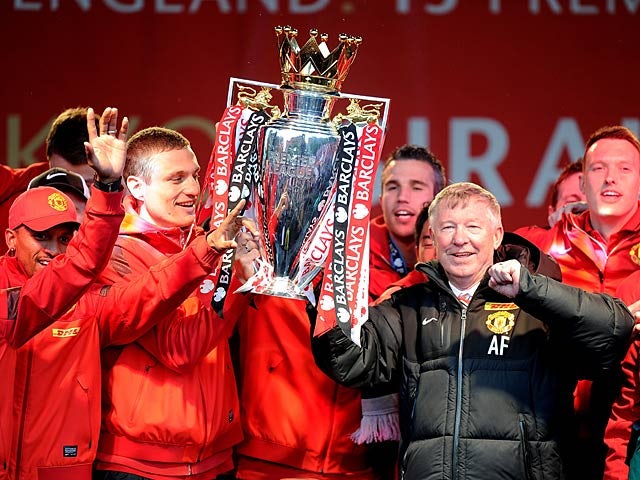 Manchester United boss Sir Alex Ferguson and his players celebrate with the Premier League trophy during the winners parade on May 13, 2013