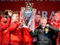 Manchester United boss Sir Alex Ferguson and his players celebrate with the Premier League trophy during the winners parade on May 13, 2013