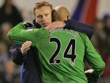 Everton boss David Moyes hugs Tim Howard after a game with Spurs on December 6, 2009