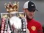 Wayne Rooney poses with the Premier League trophy