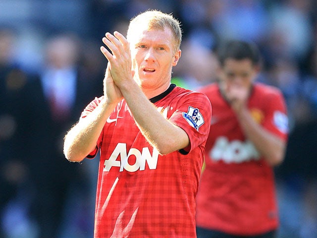 Manchester United's Paul Scholes applauds the fans after his final appearance for the club on May 19, 2013