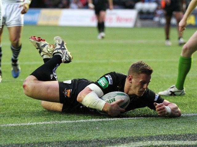 Huddersfield's Larne Patrick scores a try during the Super League against Widnes Vikings on May 17, 2013