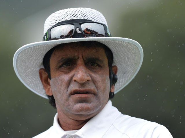 Umpire Asad Rauf looks-on as rain falls during day four of the Second Test match between New Zealand and England on March 17, 2013