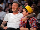 Brooklyn Beckham watches a NBA basketball game with his dad David Beckham on March 4, 2012