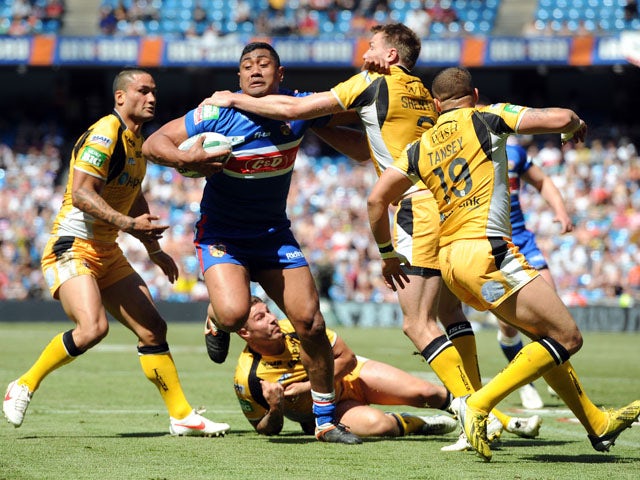 Wakefield Wildcats' Ali Lauitiiti is tackled by Castleford Tigers' Michael Shenton during the Super League match on May 25, 2013