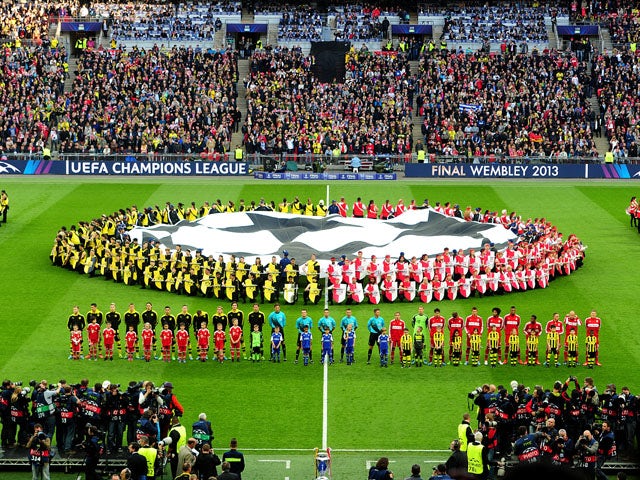 Borussia Dortmund and Bayern Munich players line up prior to kick-off on May 25, 2013