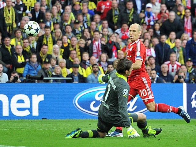 Bayern Munich's Arjen Robben has a shot deflected by Borussia Dortmund goalkeeper Roman Weidenfeller during the Champions League final on May 25, 2013