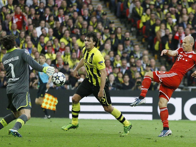 Dortmund goalkeeper Roman Weidenfeller vies for the ball with Bayern's Arjen Robben during the Champions League Final on May 25, 2013