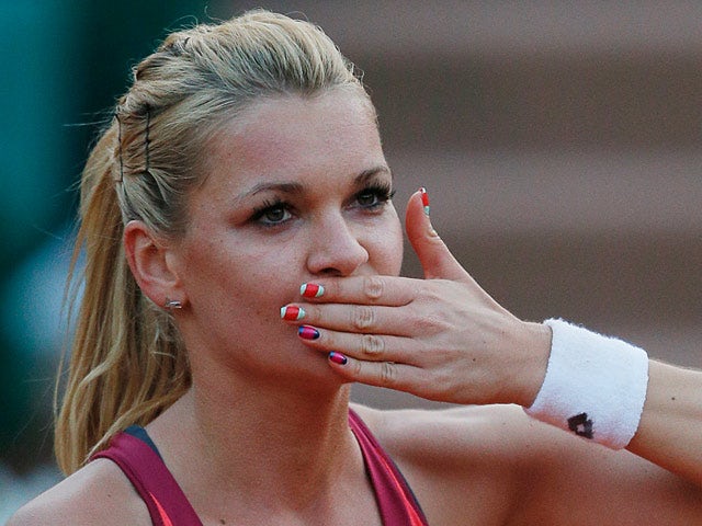 Agniezska Radwanska celebrates after defeating Ana Ivanovic during their fourth round match of the French Open on June 2, 2013