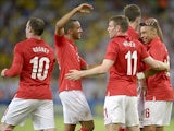 England's Alex Oxlade-Chamberlain is congratulated by team mates after scoring the equaliser against Brazil during a friendly match on June 2, 2013