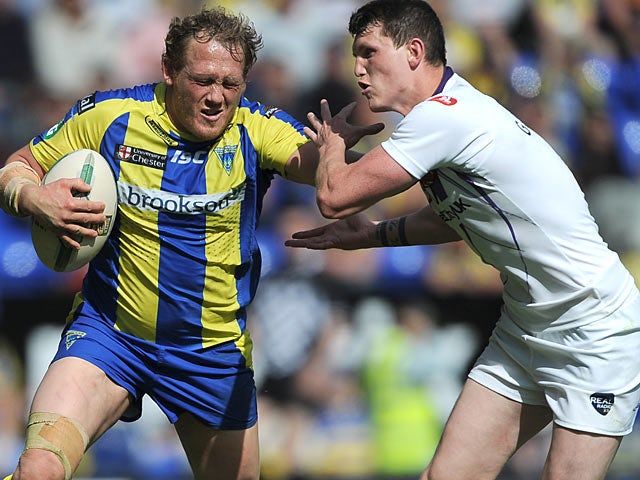 Warrington Wolves' Ben Westwood is tackled by Salford City Reds' Ashley Gibson on June 2, 2013