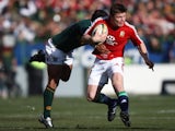 British and Irish lions player Brian O'Driscoll tries to break through a tackle from South Africa's Adi Jacobs on June 27, 2009