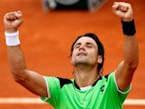 David Ferrer celebrates after defeating Albert Montanes during their second round match of the French Open on May 29, 2013