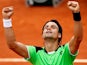 David Ferrer celebrates after defeating Albert Montanes during their second round match of the French Open on May 29, 2013