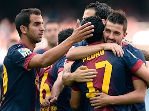 Barcelona's David Villa is congratulated by team mates after scoring the opening goal against Malaga on June 1, 2013