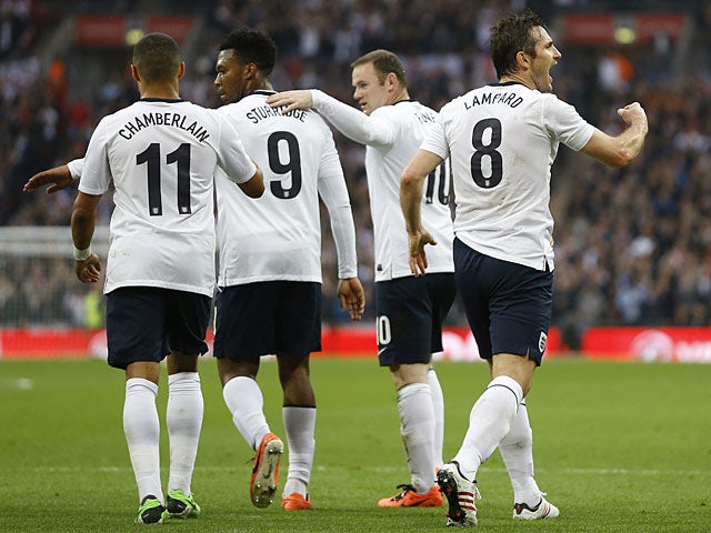 England's Frank Lampard celebrates his equaliser with team mates in the match against Ireland on May 29, 2013