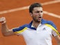 Gilles Simon celebrates after defeating Sam Querrey during their third round match of the French Open on May 31, 2013