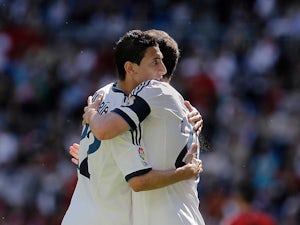 Real's Gonzalo Higuain is congratulated by team mate Angel Di Maria after scoring the opening goal against Osasuna on June 1, 2013