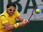 Janko Tipsarevic returns the ball to Nicolas Mahut during their first round match of the French Open on May 29, 2013