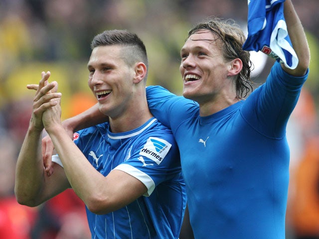 Hoffenheim's Matthieu Delpierre and Jannik Vestergaard of Denmark celebrate after beating Dortmund 2-1 on May 18, 2013
