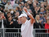John Isner celebrates after defeating Ryan Harrison during their second round match of the French Open on May 31, 2013