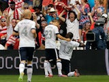USA's Jozy Altidore celebrates with team mate Fabian Johnson and fans after scoring the opening goal against Germany in a friendly match on June 2, 2013