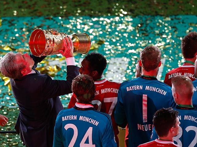 Bayern boss Jupp Heynckes celebrates with the cup after his team won the German Soccer Cup against Stuttgart on June 1, 2013