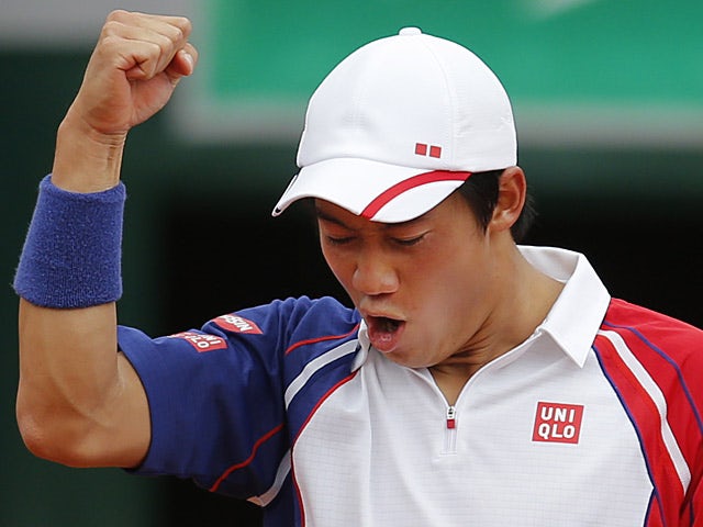 Kei Nishikori celebrates after defeating Benoit Paire during their third round match of the French Open on June 1, 2013