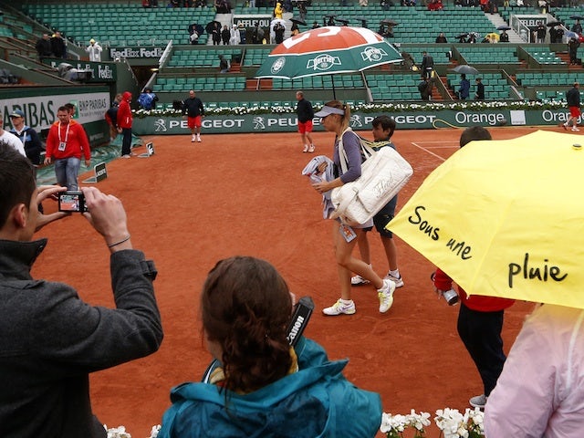 Maria Sharapova leaves the court after another rain delay as she plays Canada's Eugenie Bouchard on May 30, 2013