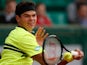 Milos Raonic returns the ball to Michael Llodra during their second round match of the French Open on May 29, 2013