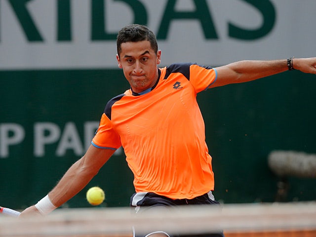 Nicolas Almagro returns the ball to Edouard Roger-Vasselin during their second round match of the French Open on May 29, 2013