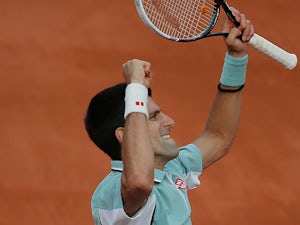 Novak Djokovic celebrates after defeating Grigor Dimitrov during their third round match of the French Open on June 1, 2013