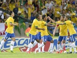 Brazil's Paulo Paulinho is congratulated by team mates after scoring his team's second goal against England during a friendly match on June 2, 2013
