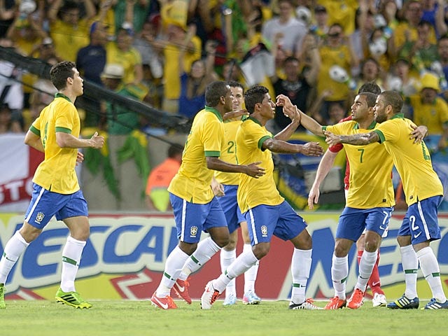 Brazil's Paulo Paulinho is congratulated by team mates after scoring his team's second goal against England during a friendly match on June 2, 2013